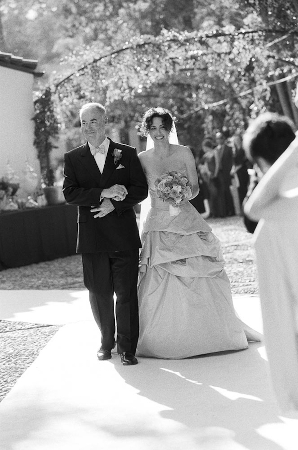 Black and white photo of father walking bride down the aisle - wedding photo by top Austin based wedding photographers Q Weddings